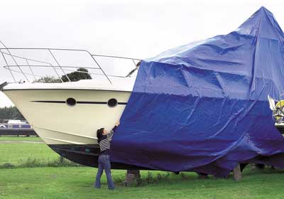 Tarps UK Online team checking heavy-duty tarpaulin quality before dispatch