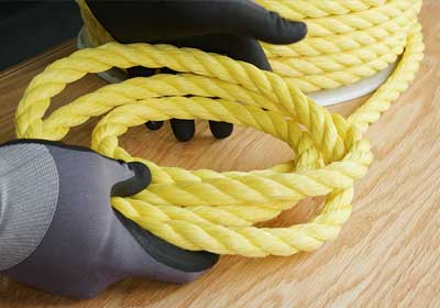Strong yellow polypropylene rope coiled neatly for industrial and household use